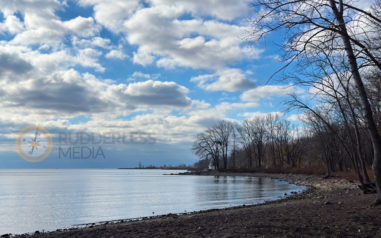 a rocky beach with trees and water - biking trails toronto