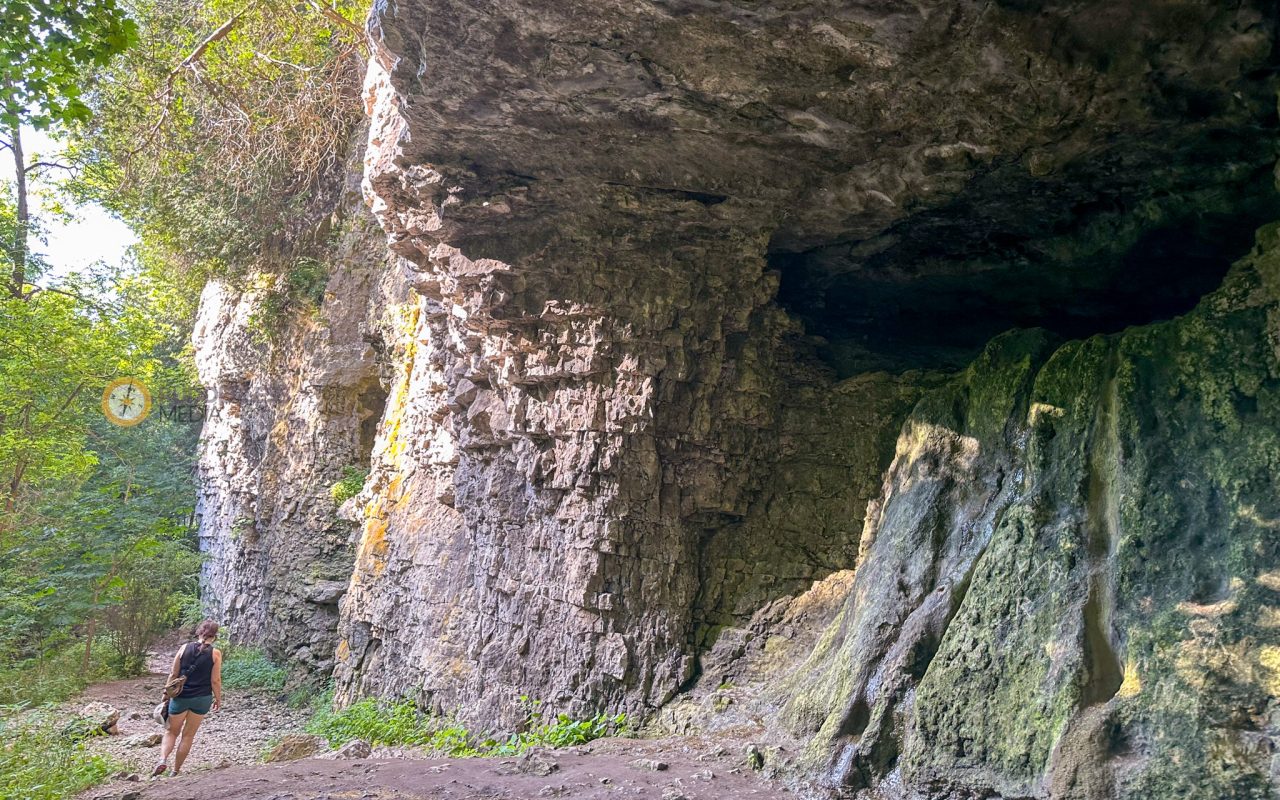 elora gorge hiking - a rock formation with a cave in the background