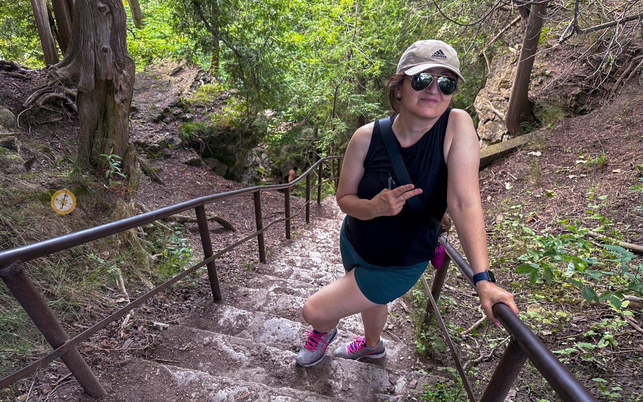 hiking elora gorge - a woman posing on a staircase in the woods