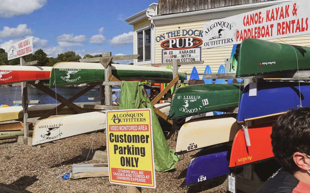 racks of canoes on display outside of an Algonquin Outfitters store