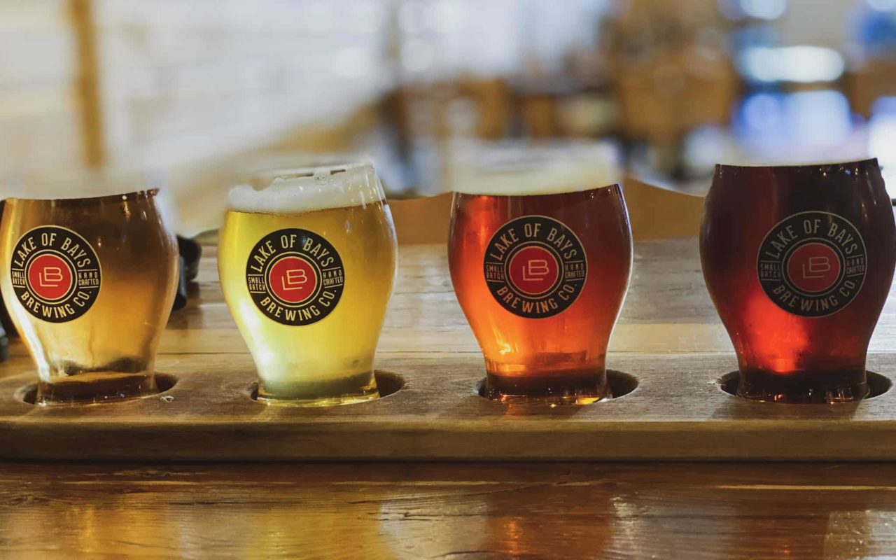 a flight of beer on the table in Lake of Bays Brewing Co glasses