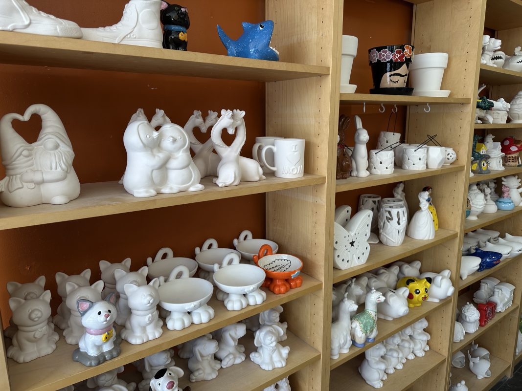 shelves with different kinds of ceramic animals on it