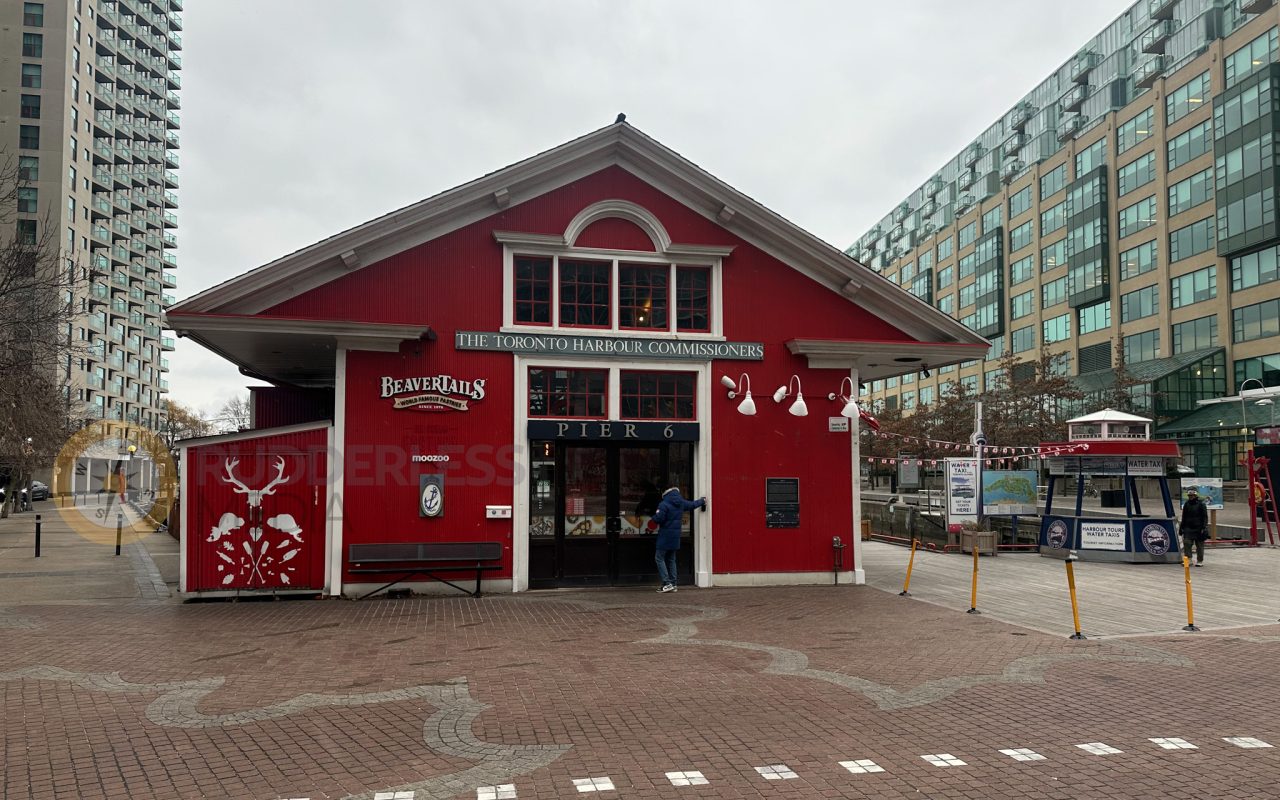 a red building with a person in the door - martin goodman trail
