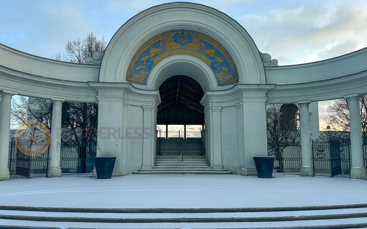 a white building with a gate and steps