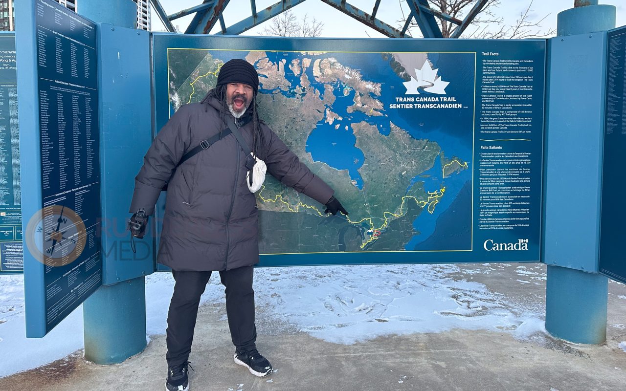 a man in a coat pointing at a map