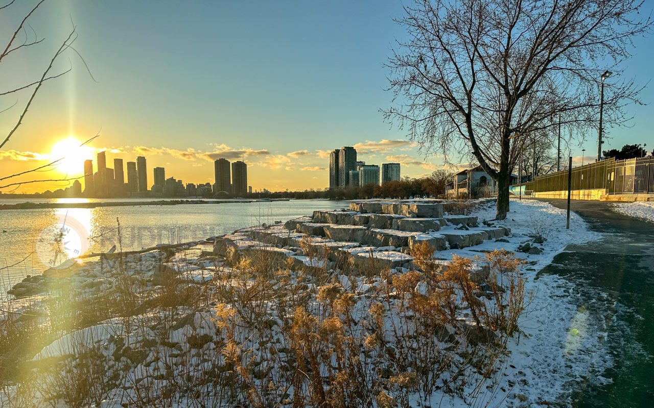 a snowy landscape with a city in the background