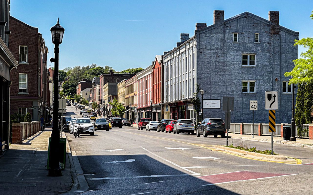 view of the main street of Port Hope, Ontario during the day with several vehicles
