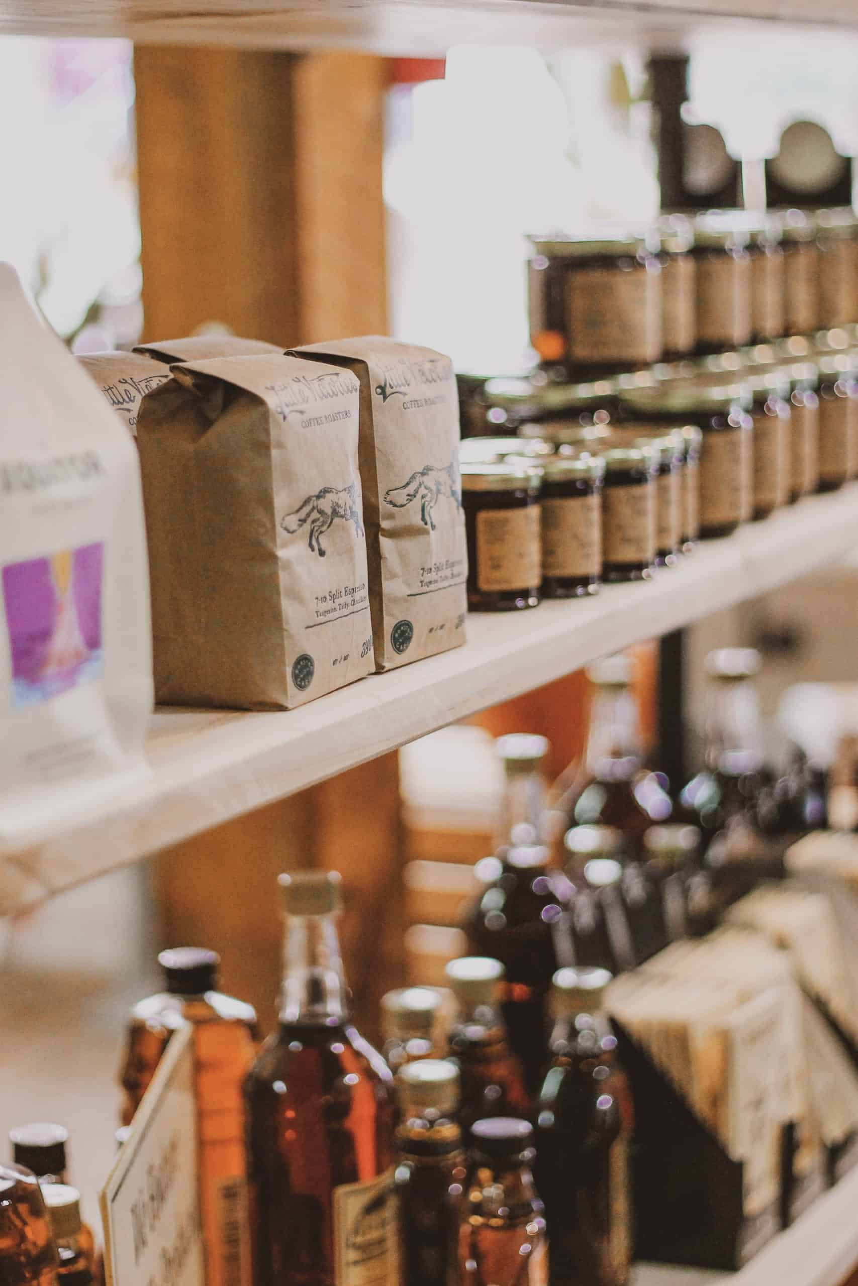 Photo of a shelf, showcasing jars and bottles as sold in Almonte shops