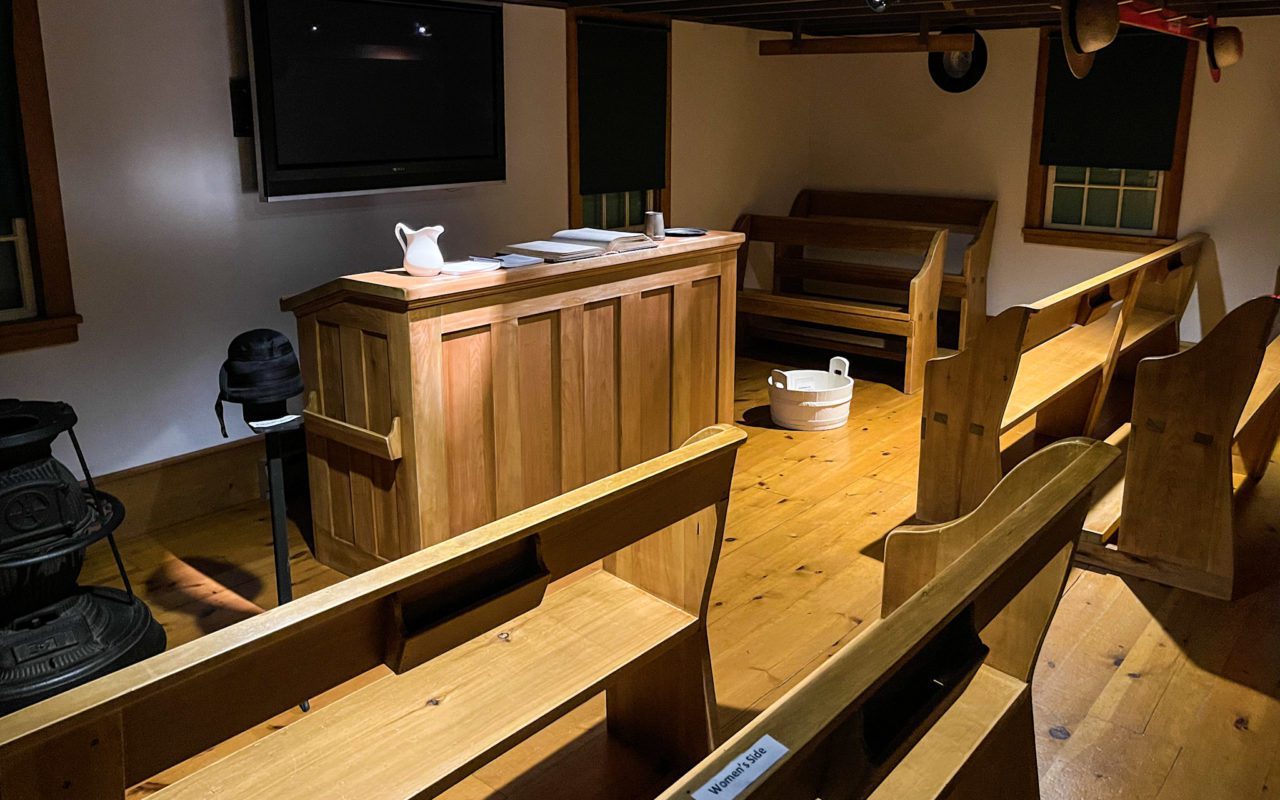 View of wooden benches and other furniture inside a Mennonite Museum | st jacobs tourism