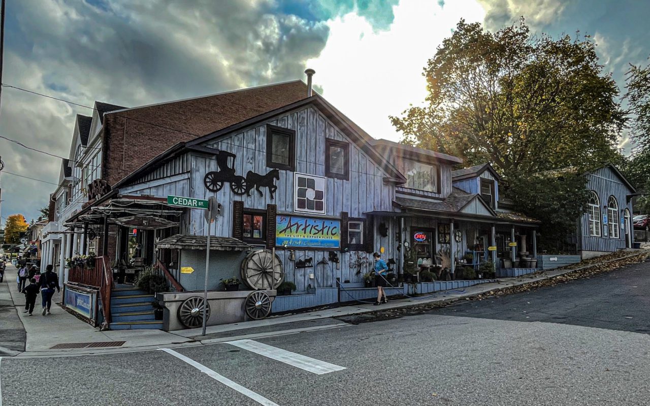 Wooden building decorated with wagon wheels and silhouettes of horse-drawn wagons | st jacobs village