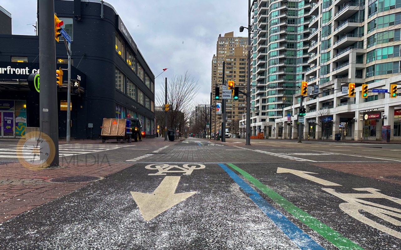a street with a bike lane and traffic lights - toronto lakefront