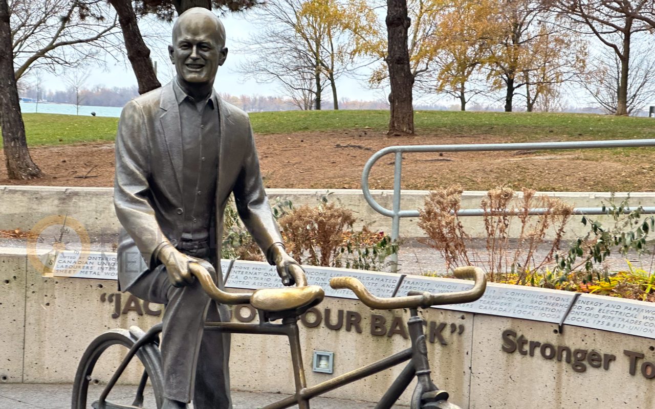 a statue of a man holding a bicycle - toronto lakefront