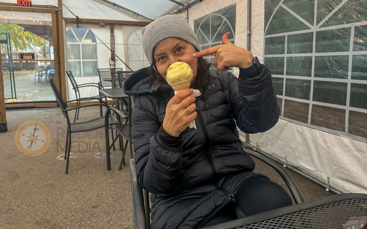 a woman holding an ice cream cone and pointing at her face - toronto waterfront trail
